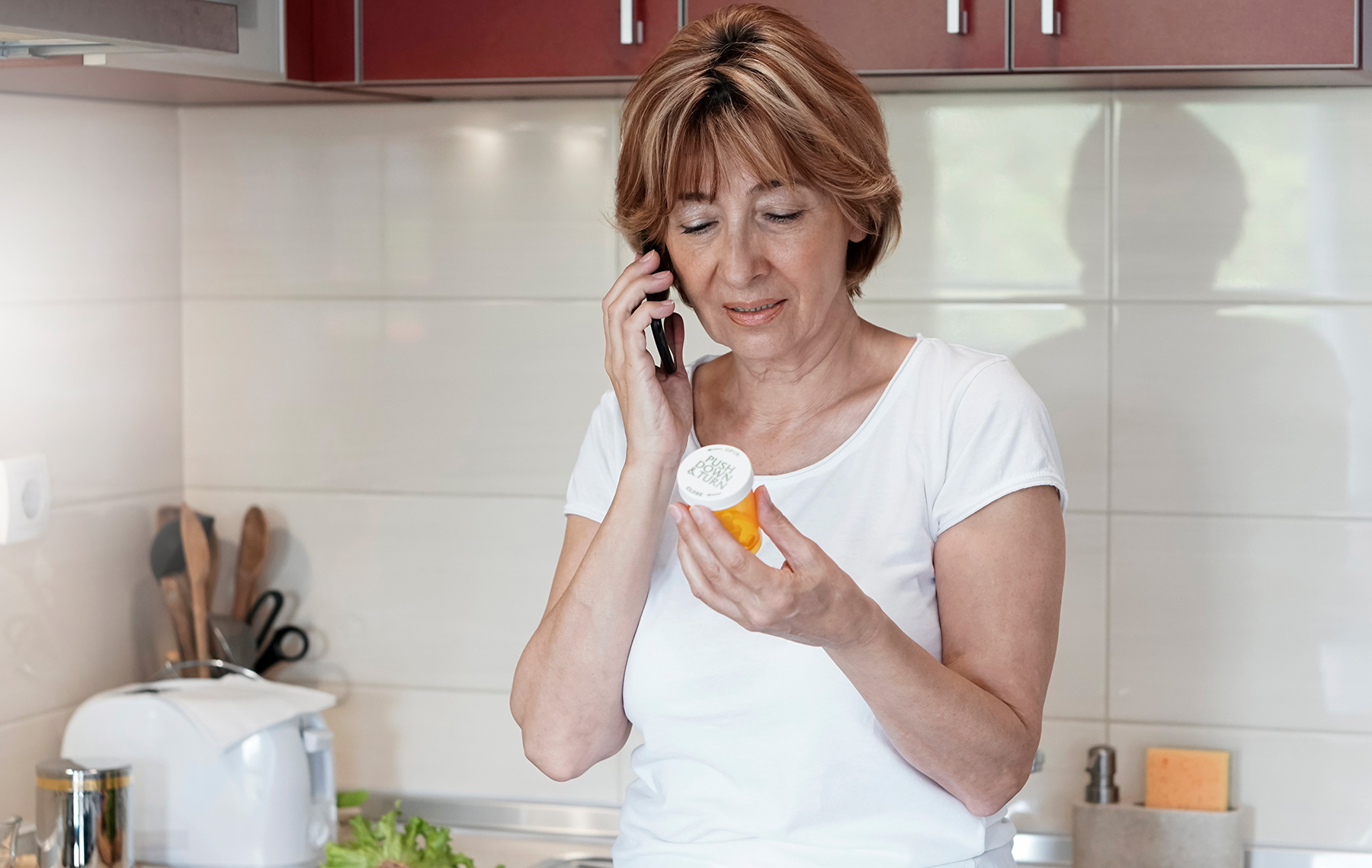 Woman on Phone Holding Meds