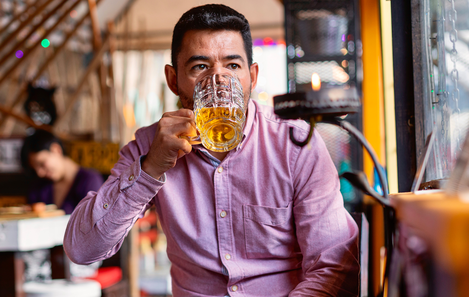 Man drinking beer in pub.