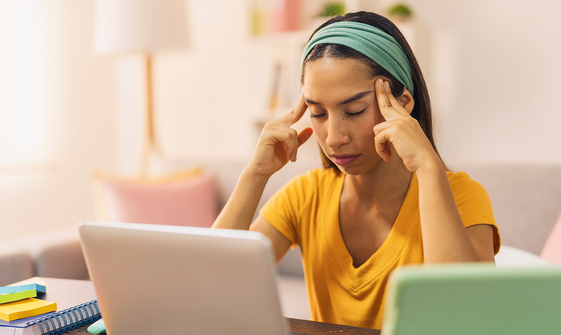 A woman is stressed as she works from home.