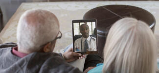 Couple in video call with doctor