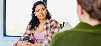 A woman speaks with her therapist.