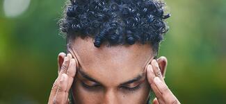 A man holds his head after suffering a concussion.