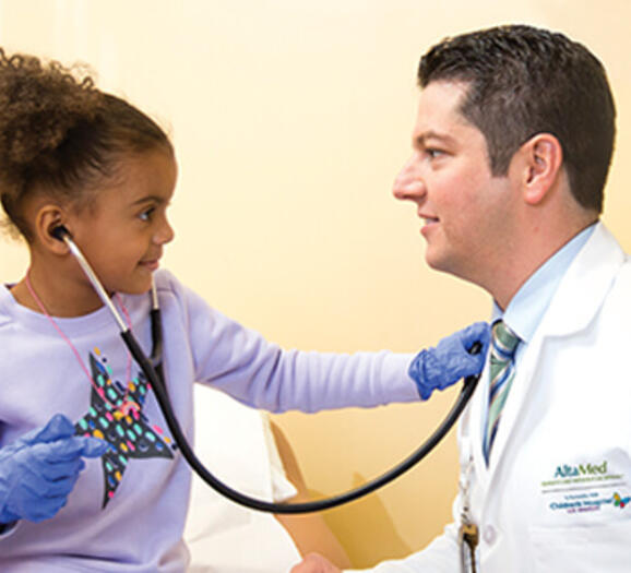 Girl hearing the hearth of a doctor