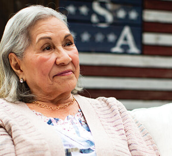 Latino woman with a USA flag in the background